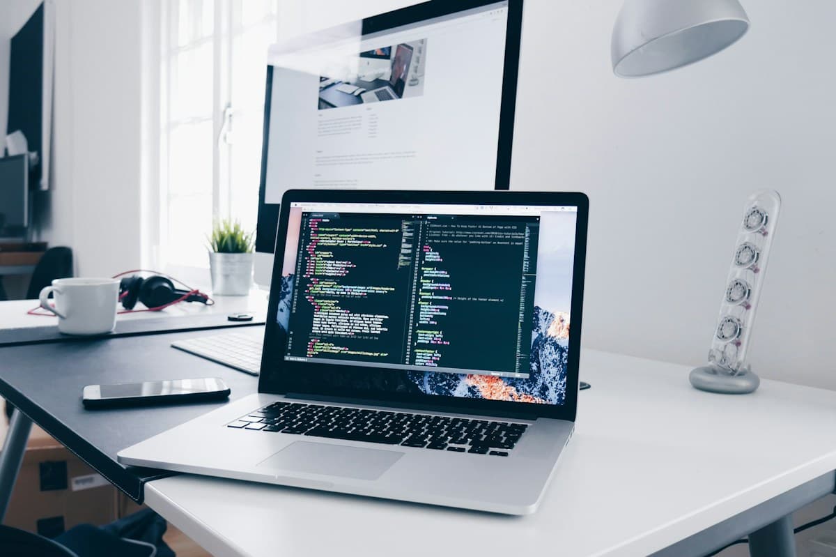 An open laptop with code in a bright everyday workspace