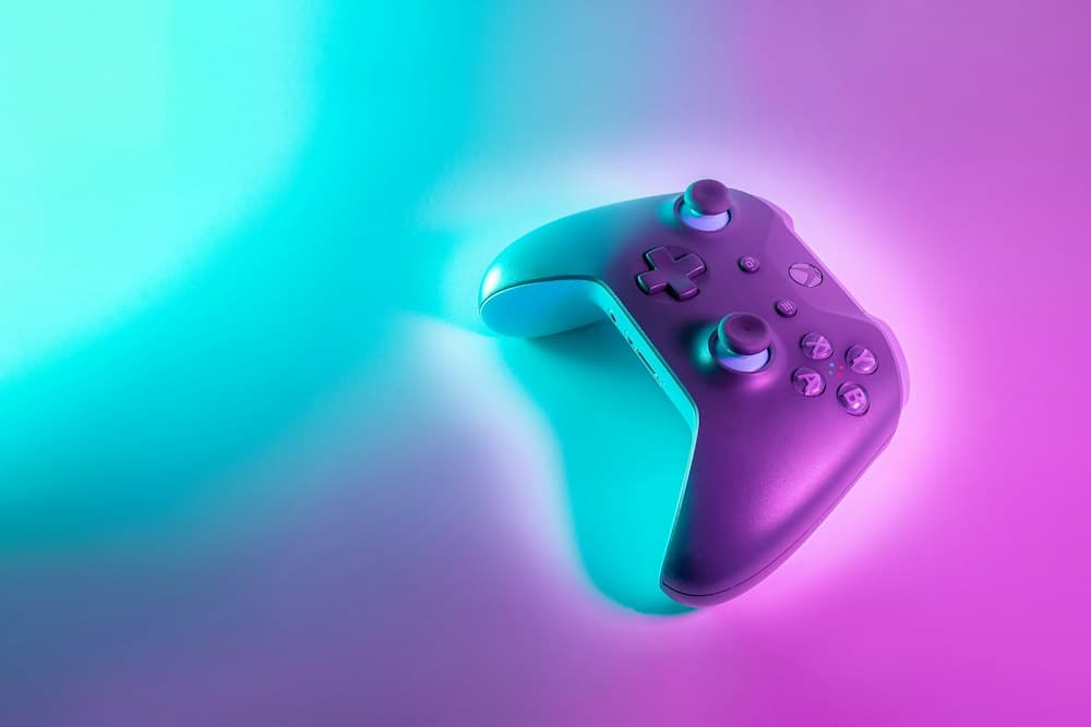 Game controller lit in purple and turquoise